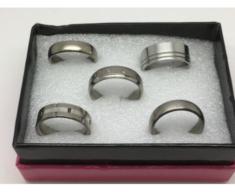 Five gents titanium rings including a diamond set example.
