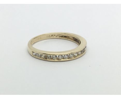 A 9carat yellow gold half hoop eternity ring set with a single row of brilliant cut diamonds ring size M