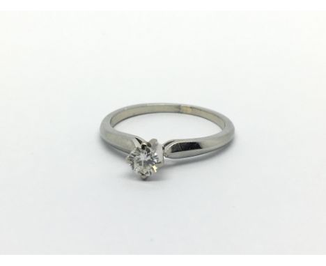 An 18ct white gold solitaire diamond ring, approx .20ct, approx 2g and approx size K.