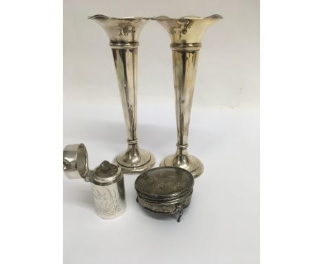 Two silver trumpet vases a silver perfume bottle and a broken trinket box .