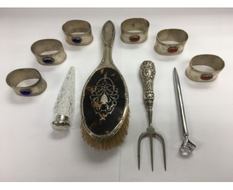 A collection of silver and white metal items comprising a silver and tortoiseshell backed brush, a silver handled trident etc