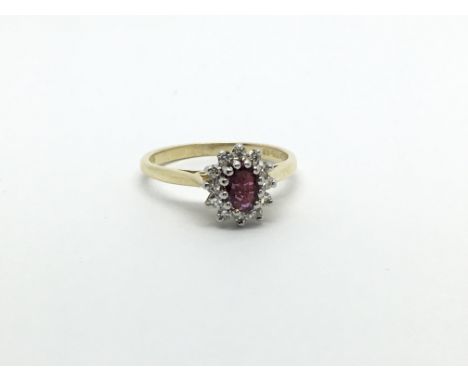 An 18ct gold ruby and diamond cluster ring, approx 2.5g and approx size I-J.