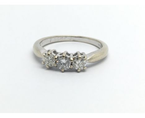 An 18ct white gold three stone diamond ring, approx 1/2ct, approx 2.9g and approx size L.