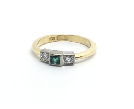 An 18ct gold ring set with a central emerald and a diamond either side, approx 3.2g and approx size J-K.