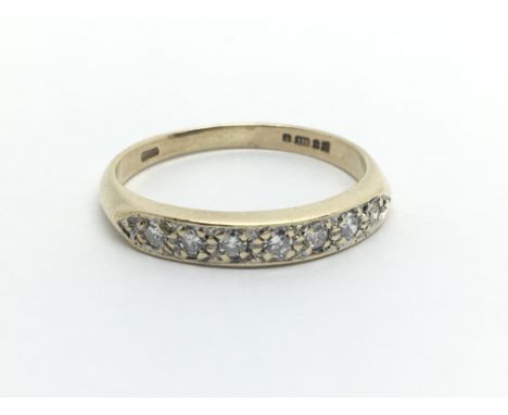 A 9ct gold half eternity ring set with seven diamonds, approx .20ct, approx 1.8g and approx size K.