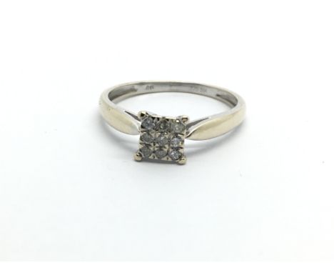 A 9ct white gold ring set with nine diamonds, approx .12ct, approx 1.5g and approx size O.