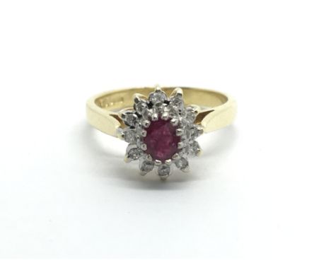 An 18ct gold eing set with a central ruby surrounded by diamonds, approx 3g and approx size H-I.