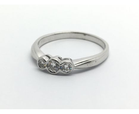 An 18ct white gold three stone diamond ring, approx .25ct , approx 3.2g and approx size R.