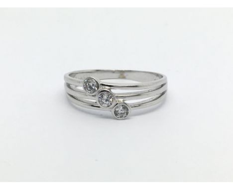 A 14ct white gold three stone diamond ring, approx .15ct, approx 2.3g and approx size O-P.