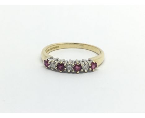 An 18carat gold ring set with alternating ruby and diamonds ring size I-J