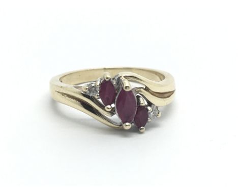 A 9ct gold ring set with two small diamonds and three faux rubies, approx 3g and approx size L.