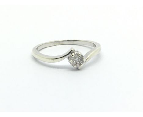 A 9ct white gold ring set with seven small diamonds in the form of a flowerhead, approx 1.8g and approx size O-P.