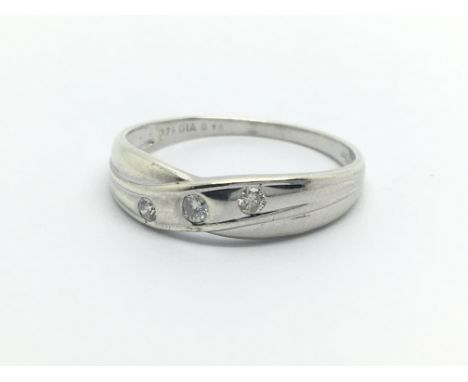 A 9ct white gold three stone diamond ring, approx .10ct, approx 1.4g and approx size P.