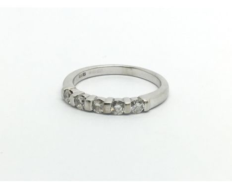 An 18carat gold ring set with a row of five brilliant cut diamonds ring size J-K