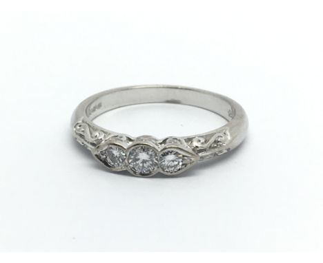 An 18carat white gold ring set with three diamonds 0.25 of a carat ring size O.