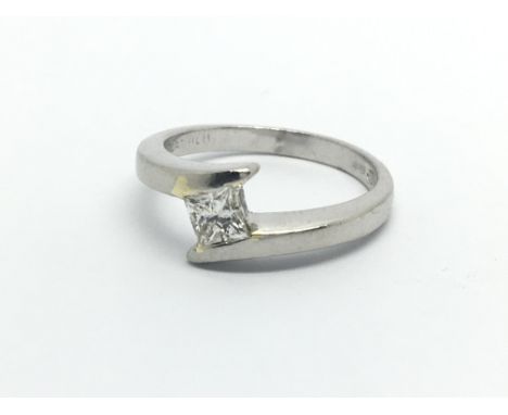 A platinum solitaire diamond ring set with a princess cut diamond, approx .25ct, approx 4.9g and approx size I-J.