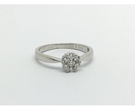 An 18carat gold ring set with a round pattern of diamonds ring size K