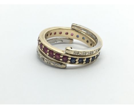 A 9ct gold flip flap ring set with diamonds, rubies and sapphires, approx 4.4g and approx size K.