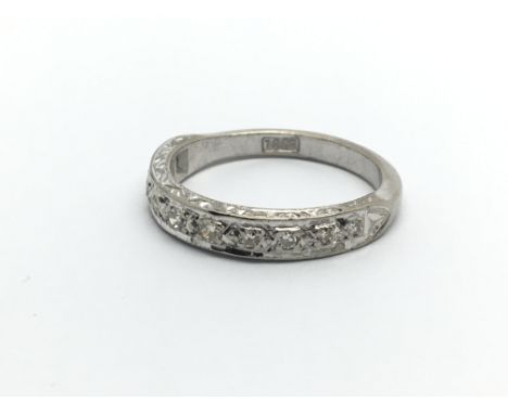 An 18ct white gold ten stone half eternity diamond ring, approx .10ct, approx 3.3g and approx size K-L.