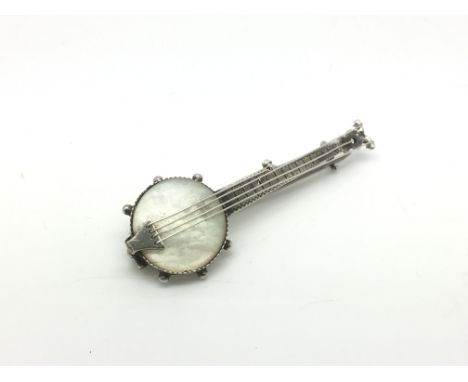 A Victorian silver and mother of pearl brooch in the form a banjo.