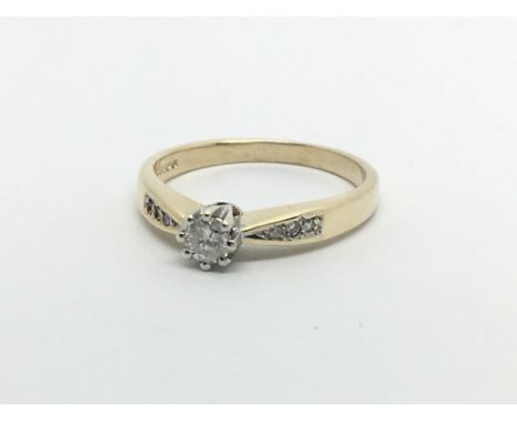 A 9carat gold ring set with a solitaire diamond 0.15 the shank with further diamonds ring size P.