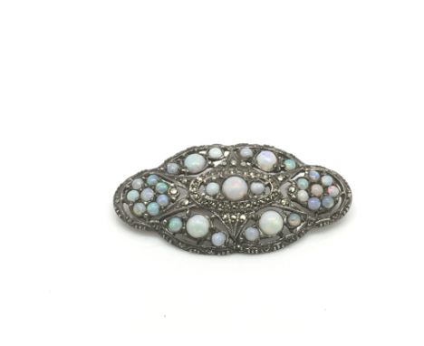 An antique silver and opal brooch.