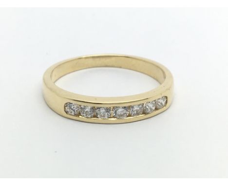 An 18ct gold ring set with seven diamonds, approx .33ct, approx 2.8g and approx size N-O.