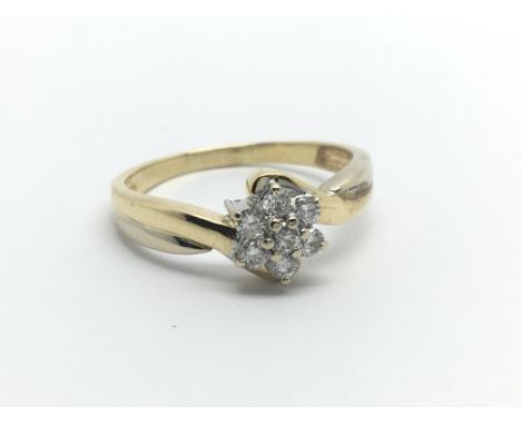 An unmarked gold ring set with seven small diamonds, approx 3.1g and approx size M.