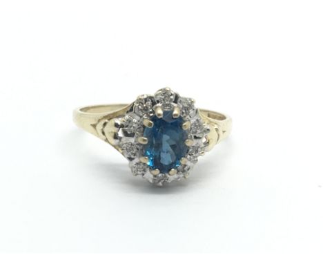A 9ct gold diamond and topaz set ring. (Y/G)