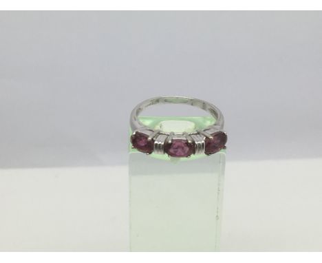 A 9ct white gold three stone ring, possibly garnets, approx 2.9g and a approx size N-O.