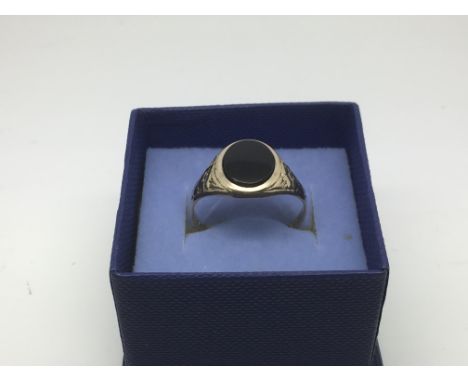 A 9ct gold signet ring set with black agate, approx 2.6g and approx size U-V.
