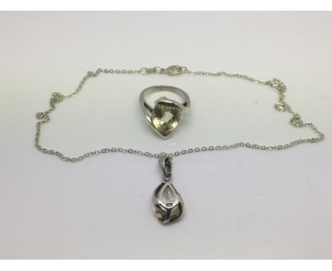 A silver pendant set with a single citrine stone plus citrine silver ring (2).