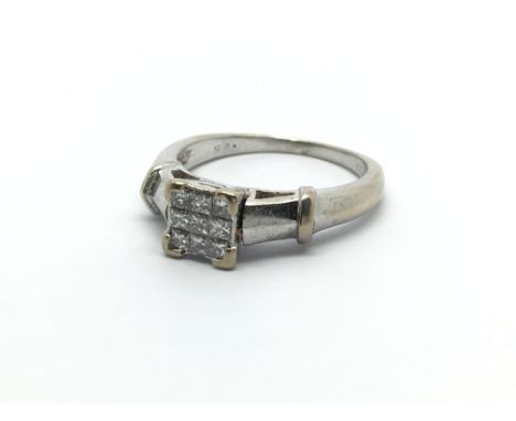 An 18ct white gold ring set with nine princess cut diamonds, approx 4.5g and approx size K-L.