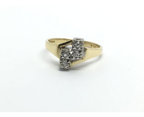 An 18ct gold ring set with four diamonds, approx 3.4g and approx size J-K.