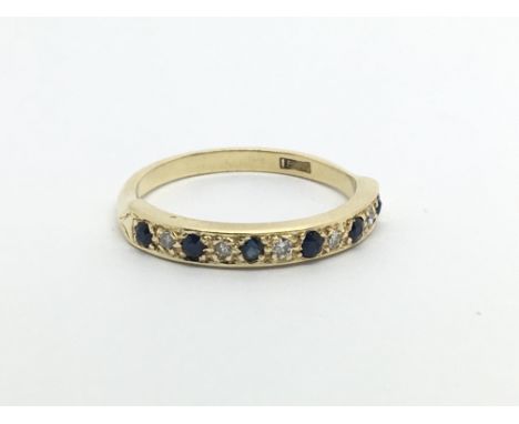 An 18carat gold ring set with alternating sapphire and diamonds ring size N.