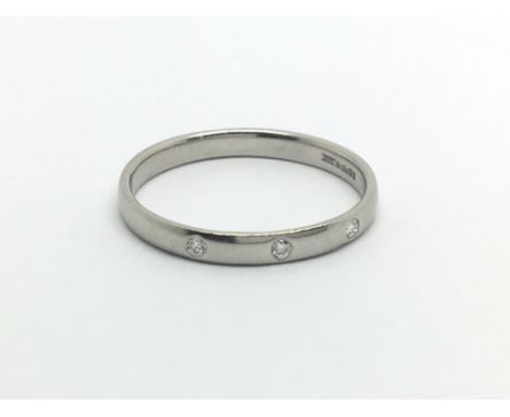 A platinum ring set with three small diamonds, approx 2.3g and approx size M.