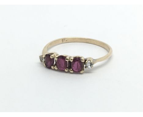 A 9ct ruby and diamond set ring, (J).