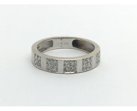 An 18ct white gold and illusion set diamond ring, (J).