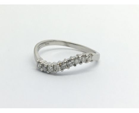 An 18ct white gold nine stone diamond ring, approx .20ct, approx 2g and approx size L.