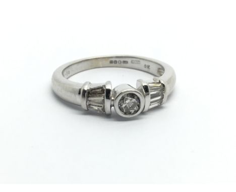 A 9ct white gold ring set with three diamonds, approx 1/2ct, approx 2.7g and approx size K.