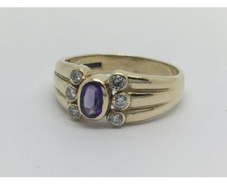 A 9carat gold ring set with amethyst And flanked by six diamond ring size P-Q