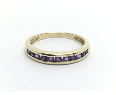 A 9ct gold half eternity ring set with amethyst, approx 1.8g and approx size N-O.