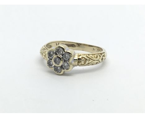 A 9carat gold ring set with a floral pattern of diamonds. 0.25 of a carat approximately. ring size H