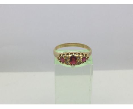 A yellow metal ring set with rubies, approx 2.8g and approx size R-S.