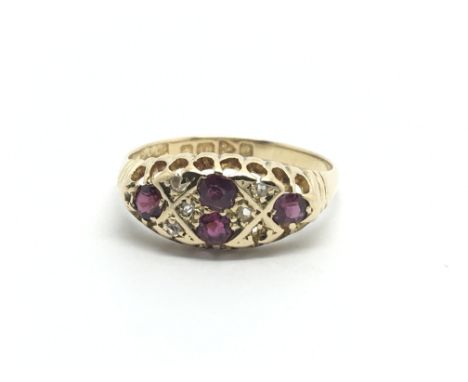 An 18carat gold ring set with four ruby and small chip stone diamonds ring size P-Q