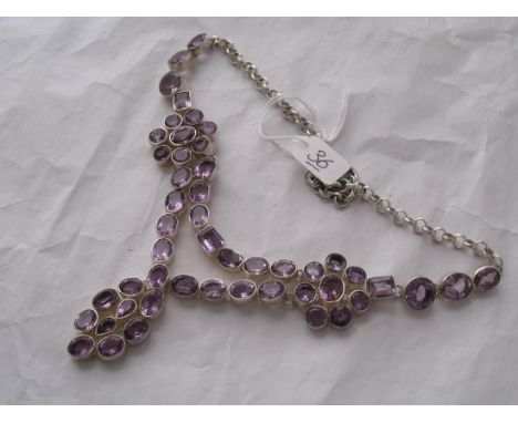 An impressive  heavy silver mounted Amethyst set   necklace consisting of 49 large faceted rectangular,   round, pear shaped 