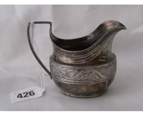A small helmet shaped cream jug with leaf embossed   girdle 4” over handle Birm 1893  65g    