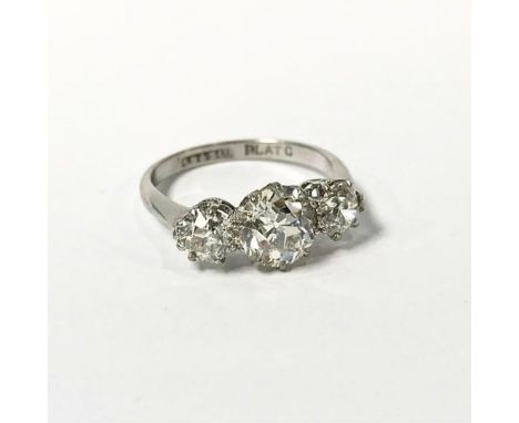 A platinum three stone diamond ring, central stone approx. 1.5ct, two on shoulder approx. 0.5ct each, size 'N', 4g