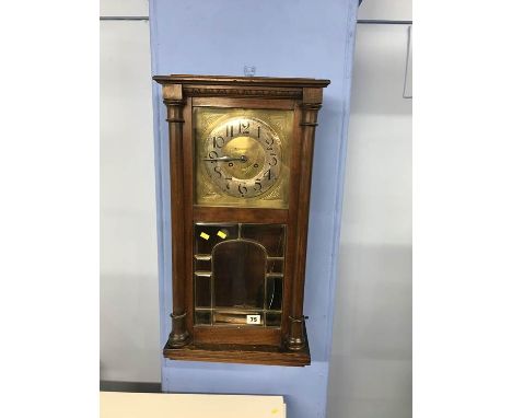 An Art Nouveau style wall clock, in the style of Charles Rennie Mackintosh, with silvered chapter ring and brass dial