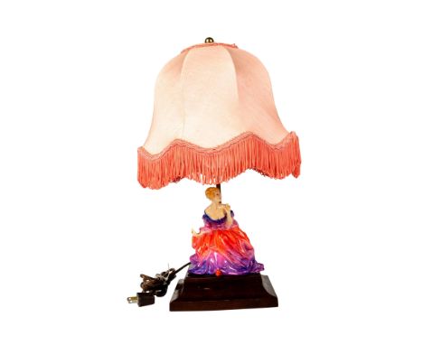 Beautiful lamp with the Lady Fayre figurine sitting on the wooden base. Fringed pink lampshade measures 10"dia. x 9"H. Condit